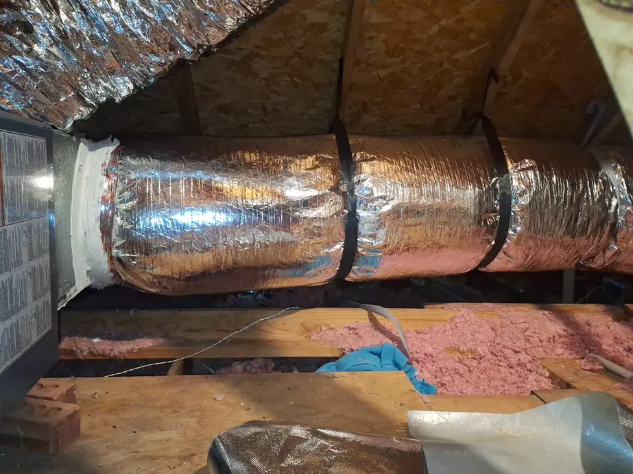 New insulated flex duct trunk sealed with mastic into a plenum, pink batt insulation below